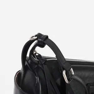 Vista detallada bolso de mujer de piel negra herrajes metálicos cremallera correa detalle