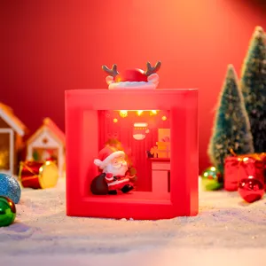 Detail of the Christmas square night light featuring Santa Claus and warm festive LED lighting inside.