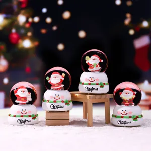 Mini Christmas snow globe with cute Santa Claus figurine, perfect holiday home decor and gift.