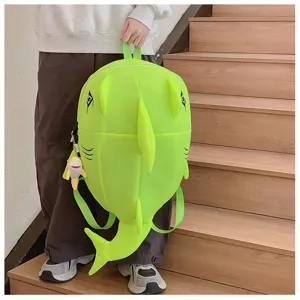 Cute green shark monster backpack with 3D fins and tail, stylish and spacious student school bag.