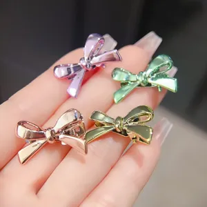 Detailansicht glänzender Metall Schleifen Haarspangen in bunten Farben mit praktischer Clipmechanik.