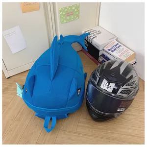 Cute blue shark monster backpack detailed view showing embroidery and large capacity design.