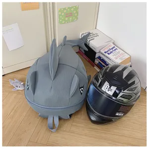 Detail shot of grey shark backpack in room scene, showing breathable mesh and large storage.