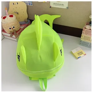 Close-up of the neon green dinosaur backpack, highlighting the 3D fin and cute embroidered eyes.