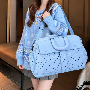 Detailed view of the large capacity polka dot travel duffel bag showing expandable design.