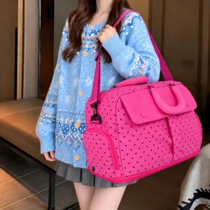 Large capacity pink polka dot travel duffel bag detail showcasing multi-pocket design and strap.