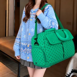Large capacity polka dot travel duffel bag showing detailed interior and shoulder strap.