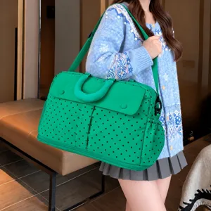 Green polka dot travel duffel bag detail, large capacity waterproof storage bag for short trips.