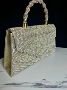 Pearl rhinestone evening bag detail, gold clutch purse handle showcase close-up display.