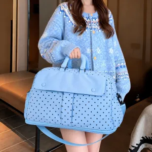 Large capacity travel duffel bag in light blue with black polka dots, practical and stylish.