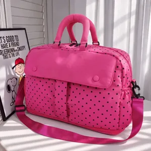 Pink polka dot travel bag detail view, spacious weekender duffel for short trips and daily gym use.