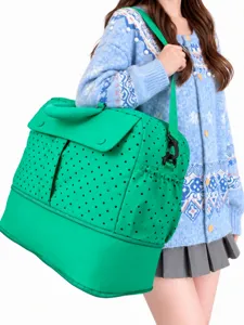 Large capacity travel duffel bag with green polka dots, expandable gym and luggage bag for women.