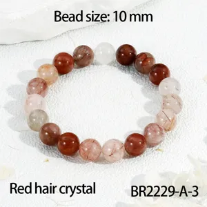 Gedetailleerd overzicht van natuurlijke rode rutielkwarts 10mm kralen armband sieraden