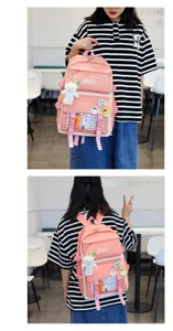 Pink canvas school backpack with multi pockets, cute bear pendant, and badges for students.