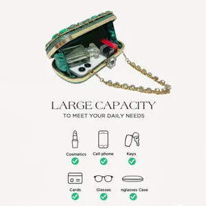 Green rhinestone evening clutch bag with gold chain strap, luxury crystal handbag detail view.
