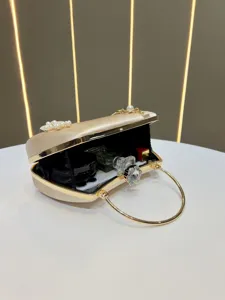 Elegant satin evening clutch bag with pearl and crystal details, perfect party accessory.