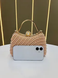 Elegant pearl evening clutch bag with gold metal frame and sparkling rhinestones for women.