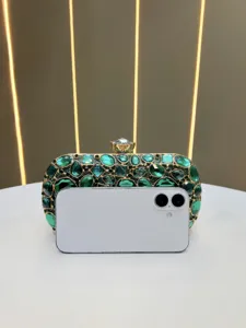Exquisite green crystal evening clutch bag detail showing sparkling rhinestones and gold frame.