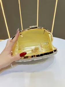 Close-up view showing the smooth yellow satin interior lining and gold metal chain inside.