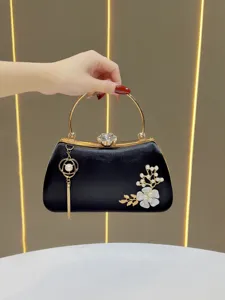 Elegant black evening clutch bag with pearl flower and gold handle for women parties.