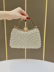 Elegant pearl evening bag detail, sparkling rhinestones and metal handle for special events.