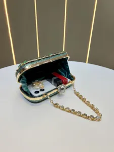 Exquisite green sparkly evening clutch bag with crystal clasp and chain for elegant dress events.