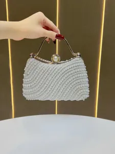 Elegant pearl evening bag detail shot, featuring exquisite handmade beadwork and luxury metal clasp.