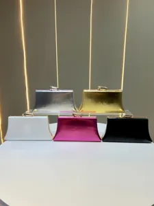 Detail view of elegant metallic evening clutch bags in multiple colors with sleek clasp.