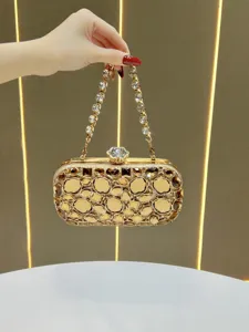 Exquisite gold rhinestone evening clutch bag detail, sparkling crystals and chic chain strap.