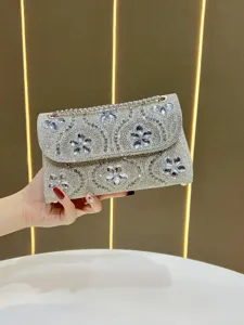 Silver rhinestone evening bag detail, sparkling crystal flowers and chain strap close-up.