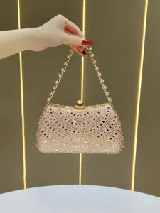 Exquisite rhinestone evening clutch bag detail, sparkling crystals with gold chain strap.