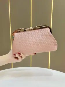 Pink woven clutch evening bag with metal frame lock, elegant stylish accessory for women.