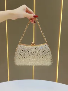 Exquisite rhinestone evening clutch bag detail, sparkling crystals and gold metal chain strap.