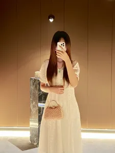 Elegant pearl beaded evening handbag detail shot, versatile crossbody chain bag style scene view.