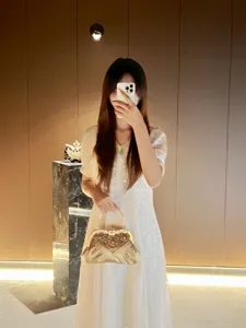 Elegant rhinestone evening handbag with metal kiss lock and satin pleated design for women.