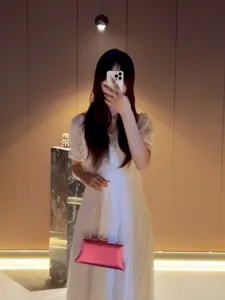 Elegant pink metallic evening clutch bag, stylish crossbody and shoulder bag for women.