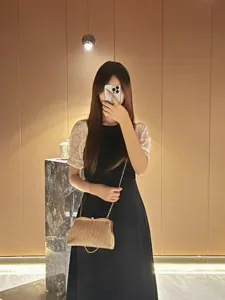 Elegant metallic evening clutch bag with chain strap, stylish women crossbody bag detail view.