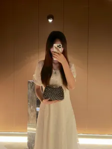 Elegant black beaded wave clutch bag for women, sparkling evening party handbag with metal clasp.