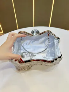 Detailed view of sparkly rhinestone evening clutch bag with crystal clasp and chain strap.