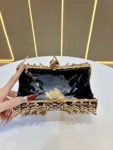 Exquisite rhinestone evening clutch bag detail view, showing inner chain and luxury design.
