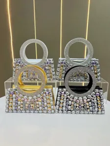 Detailed view of luxury rhinestone evening handbags featuring sparkling crystal circular handles.