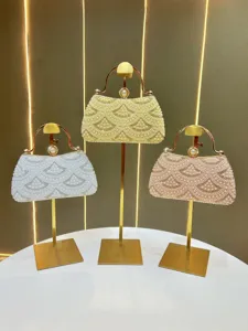 Exquisite pearl rhinestone evening bag detail, luxury metallic frame clutch purse for women.