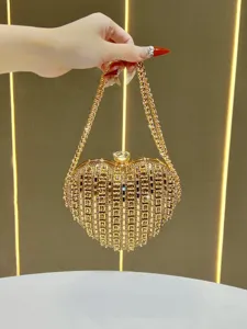Gold heart-shaped rhinestone evening clutch bag with chain handle, elegant detail view.