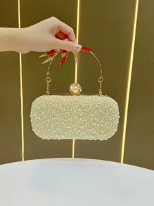 Exquisite pearl evening clutch bag detail, featuring golden metal ring handle and pearl clasp.