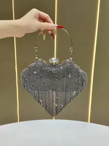 Close-up detail of luxury rhinestone heart evening bag with sparkling crystals and metal handle.