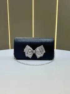 Elegant black rhinestone bow evening clutch bag with silver chain strap for banquet parties.