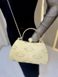 Elegant pearl rhinestone evening clutch bag detail, exquisite metallic frame clasp.