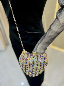 Exquisite heart-shaped rhinestone evening bag with sparkling crystals and gold chain detail.