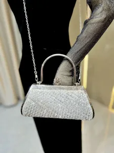 Sparkling rhinestone evening bag detail shot, elegant silver chain shoulder bag showcase.