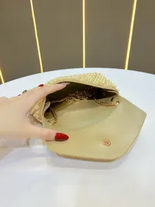Gold pearl evening clutch bag with rhinestone chain, elegant shoulder handbag for party events.